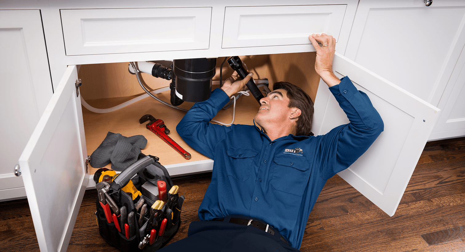 Tech inspecting under sink