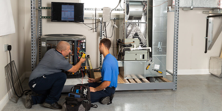 Ierna's Heating & Cooling techs working together on air conditioning repair services